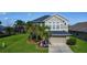 Two-story home with well-manicured lawn, front yard landscaping, and a two-car garage at 2530 The Oaks Blvd, Kissimmee, FL 34746