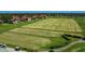 Overhead shot showcasing a well-groomed golf course, lush greenery, and neatly arranged tee boxes at 2530 The Oaks Blvd, Kissimmee, FL 34746