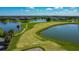 Gorgeous golf course aerial of winding greens bordered by calm lakes in a residential area at 2530 The Oaks Blvd, Kissimmee, FL 34746