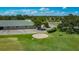 Picturesque golf course view showcasing a sand trap, lush green fairways, and clubhouse on a sunny day at 2530 The Oaks Blvd, Kissimmee, FL 34746