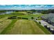 Panoramic aerial showcases the well-kept golf course, the clubhouse, and neatly arranged golf carts next to manicured landscapes at 2530 The Oaks Blvd, Kissimmee, FL 34746