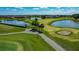 Beautiful golf course view showcasing mature palm trees, a serene lake, and lush fairways at 2530 The Oaks Blvd, Kissimmee, FL 34746