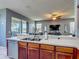 Open kitchen with wood cabinets, stainless steel appliances, and a view into the living area at 2530 The Oaks Blvd, Kissimmee, FL 34746