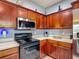 Well-equipped kitchen featuring dark wood cabinets and modern stainless steel appliances at 2530 The Oaks Blvd, Kissimmee, FL 34746