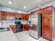 Modern kitchen with stainless steel appliances, tile flooring, and ample cabinet space at 2530 The Oaks Blvd, Kissimmee, FL 34746