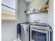 Modern laundry room features updated appliances and ample storage at 2530 The Oaks Blvd, Kissimmee, FL 34746