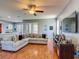 Open-concept living room boasting hardwood floors and a large sectional sofa at 2530 The Oaks Blvd, Kissimmee, FL 34746