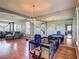 Open-concept living room with hardwood floors, a staircase, and a large mirror accent wall at 2530 The Oaks Blvd, Kissimmee, FL 34746