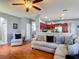 Bright and airy living room with hardwood floors, neutral walls, and an open concept design at 2530 The Oaks Blvd, Kissimmee, FL 34746