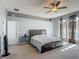 Spacious main bedroom with a ceiling fan, carpeted floors and a sitting area at 2530 The Oaks Blvd, Kissimmee, FL 34746