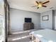 A large main bedroom with a ceiling fan and natural light at 2530 The Oaks Blvd, Kissimmee, FL 34746