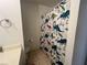 This bathroom has a toilet and a bathtub with a white dinosaur themed shower curtain at 2770 Club Cortile Cir # A, Kissimmee, FL 34746