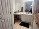 This bathroom has a white vanity with a long mirror and a black bathmat on the floor at 2770 Club Cortile Cir # A, Kissimmee, FL 34746
