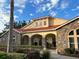 Clubhouse with stone accents, covered entryway, and well-maintained landscaping at 2770 Club Cortile Cir # A, Kissimmee, FL 34746