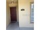 Exterior view of a front door with sidelight, address plaque, and a covered entryway at 2770 Club Cortile Cir # A, Kissimmee, FL 34746