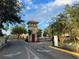 Community gate with clock tower and lush landscaping creating a welcoming entrance at 2770 Club Cortile Cir # A, Kissimmee, FL 34746