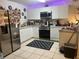 Updated kitchen featuring stainless steel appliances, white cabinetry, and tile floors at 2770 Club Cortile Cir # A, Kissimmee, FL 34746