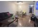 This living room has a dark couch, and a dining table with chairs, along with hard wood floors at 2770 Club Cortile Cir # A, Kissimmee, FL 34746