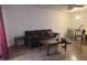 This is a view of the living room that has wood floors, and a dark gray couch next to a coffee table at 2770 Club Cortile Cir # A, Kissimmee, FL 34746