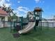 Playground with slide, climbing structures, and safe artificial turf in a gated community at 2770 Club Cortile Cir # A, Kissimmee, FL 34746