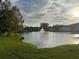Community pond with fountain surrounded by manicured lawns and residential buildings at 2770 Club Cortile Cir # A, Kissimmee, FL 34746