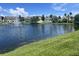 This picture shows a pond with a fountain, with houses behind it on a bright sunny day at 2770 Club Cortile Cir # A, Kissimmee, FL 34746