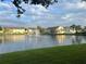 Community pond view featuring a fountain surrounded by well-maintained, colorful buildings at 2770 Club Cortile Cir # A, Kissimmee, FL 34746