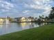 Scenic pond view with a fountain, surrounded by colorful buildings and green space at 2770 Club Cortile Cir # A, Kissimmee, FL 34746