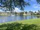 This picture has a pond with a fountain and some condominium style housing behind it on a sunny day at 2770 Club Cortile Cir # A, Kissimmee, FL 34746