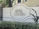 Photo of the Club Cortile sign with plants and trees in the background on a sunny day at 2770 Club Cortile Cir # A, Kissimmee, FL 34746