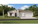 Charming single-Gathering home featuring a stone facade, two-car garage, and manicured lawn at 2931 Believe In Yourself Ct, Clermont, FL 34714