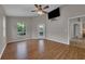 This bedroom features wood floors, a ceiling fan, and an exterior door leading to a screened patio or pool at 3196 Verbena Ct, Deltona, FL 32725