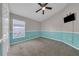 A cozy bedroom with two-tone walls, carpet, ceiling fan, and natural light from a window at 3196 Verbena Ct, Deltona, FL 32725