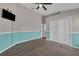 Bedroom with two-tone walls, carpet, ceiling fan, a closet, and wall-mounted television at 3196 Verbena Ct, Deltona, FL 32725