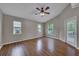 Large bedroom with wood floors, a ceiling fan, and lots of natural light from three windows at 3196 Verbena Ct, Deltona, FL 32725