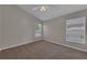 Spacious bedroom featuring neutral walls, carpet flooring, a ceiling fan, and natural light from two windows at 3196 Verbena Ct, Deltona, FL 32725