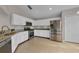 Bright kitchen featuring stainless steel appliances, granite counters, and white cabinetry at 3196 Verbena Ct, Deltona, FL 32725