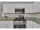 Gourmet kitchen featuring stainless steel appliances and granite countertops at 3196 Verbena Ct, Deltona, FL 32725