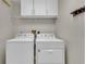Well-equipped laundry room with a washer, dryer, and ample storage space at 3196 Verbena Ct, Deltona, FL 32725