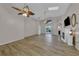 Spacious living room featuring wood floors, high ceilings, ceiling fans, and a modern fireplace and tv at 3196 Verbena Ct, Deltona, FL 32725