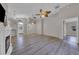 Open concept living room with wood floors, high ceilings, and decorative fan with access to other rooms at 3196 Verbena Ct, Deltona, FL 32725
