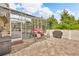 Outdoor patio featuring comfortable seating, a grill, and serene views of the pool at 3196 Verbena Ct, Deltona, FL 32725