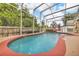 Screened-in pool area with lush greenery, perfect for outdoor relaxation at 3196 Verbena Ct, Deltona, FL 32725