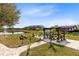 Picnic tables and a gazebo next to the lake with beautiful landscaping and hardscaping at 3201 Dallas Blvd, Orlando, FL 32833
