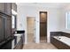 Elegant bathroom featuring dual vanity, tiled bathtub, glass enclosed shower, and walk-in closet at 3201 Dallas Blvd, Orlando, FL 32833
