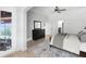 Bright bedroom featuring neutral walls, ceiling fan, area rug, and dark wood dresser at 3201 Dallas Blvd, Orlando, FL 32833