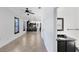 Hallway featuring neutral tile flooring leading to the kitchen and a half-bath at 3201 Dallas Blvd, Orlando, FL 32833