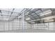 The spacious interior of the outbuilding boasts a metal roof, white metal walls, concrete floor and lighting at 3201 Dallas Blvd, Orlando, FL 32833