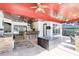 An expansive outdoor living area features a kitchen, bar seating, lounge area, ceiling fans, and decorative tile flooring at 3201 Dallas Blvd, Orlando, FL 32833