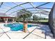 Screened in pool and a stone pillar with a fire pit located close to the pool at 3201 Dallas Blvd, Orlando, FL 32833